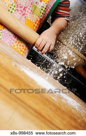 Stock photo of a four year old girl holding a rolling pin as flour is sprinkled onto the worksurface View Large Photo Image Stock Photography - Stock photo of a four year old girl holding a rolling pin as flour is sprinkled onto the worksurface. Fotosearch