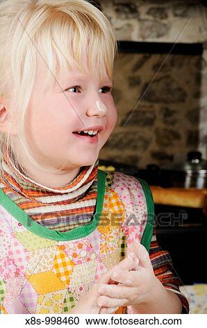 Stock photo of a laughing little girl with flour on her nose as she helps her mum do some baking in the kitchen View Large Photo Image Stock Image - Stock photo of a laughing little girl with flour on her nose as she helps her mum do some baking in the kitchen. Fotosearch