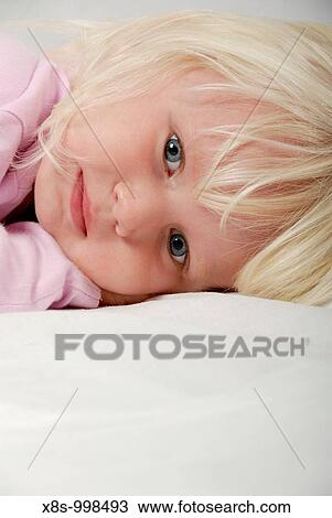 Stock Image - Stock photo of a portrait of a blond haried blue eyed three year old child. Fotosearch