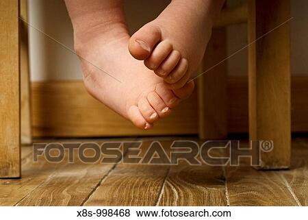 Stock photo of a toddlers bare feet dangling off a chair View Large Photo Image Stock Photo - Stock photo of a toddlers bare feet dangling off a chair. Fotosearch