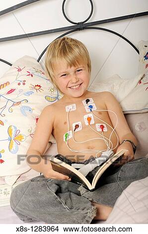 Stock photo of an 11 year old boy wearing a Holter heart monitor View Large Photo Image Picture - Stock photo of an 11 year old boy wearing a Holter heart monitor. Fotosearch