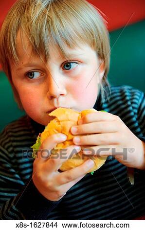 Stock photo of an 11 year old boy eating a burger View Large Photo Image Picture - Stock photo of an 11 year old boy eating a burger. Fotosearch