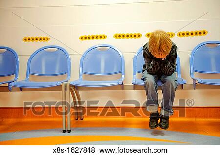 Stock photo of an 11 year old boy holding his head in his hands sitting on a waiting room chair View Large Photo Image Stock Photo - Stock photo of an 11 year old boy holding his head in his hands sitting on a waiting room chair. Fotosearch
