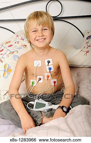 Stock photo of an 11 year old boy wearing a Holter heart monitor View Large Photo Image Stock Photograph - Stock photo of an 11 year old boy wearing a Holter heart monitor. Fotosearch