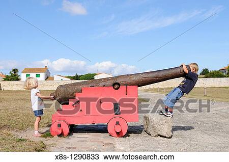 Stock photo of children playing around an old canon View Large Photo Image Stock Image - Stock photo of children playing around an old canon. Fotosearch