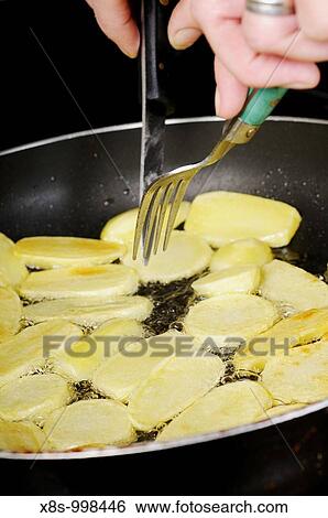 Stock photo of potatoes frying in a pan View Large Photo Image Stock Photograph - Stock photo of potatoes frying in a pan. Fotosearch