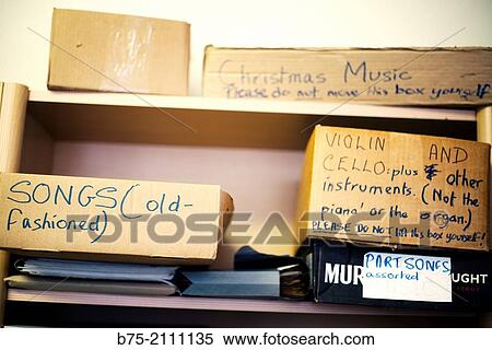 stock shelves with boxes containing sheet music. Songs, Christmas Music, Violin and Cello, Part Songs, Old Fashioned Songs. View Large Photo Image Stock Photography - stock shelves with boxes containing sheet music. Songs, Christmas Music, Violin and Cello, Part Songs, Old Fashioned Songs.. Fotosearch
