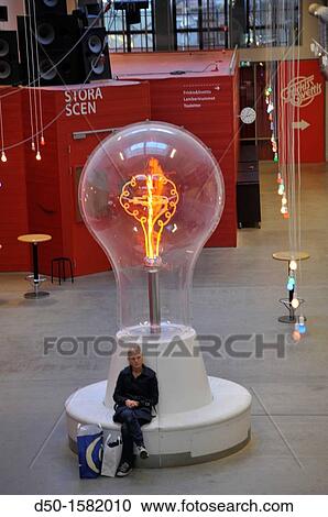 STOCKHOLM SWEDEN Dieselverkstad, a multi purpose activity center with theater, library, climbing center, cafe Here a woman sitting under a lightbulb. View Large Photo Image Stock Image - STOCKHOLM SWEDEN Dieselverkstad, a multi purpose activity center with theater, library, climbing center, cafe Here a woman sitting under a lightbulb.. Fotosearch