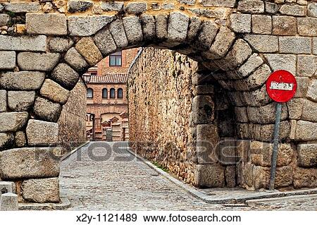 Stock Photo - Stone arch and cobble stone street, Segovia, Spain. Fotosearch