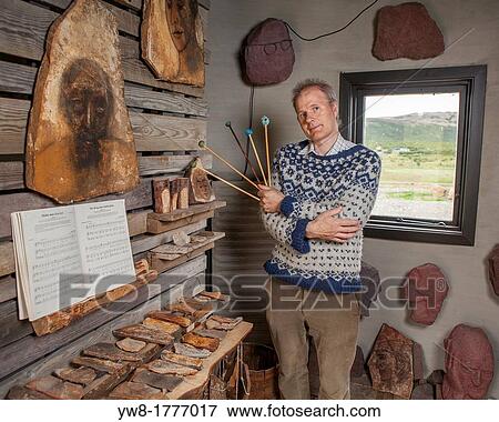 Stock Photo - Stone Artist playing a xylophone, Borgarfjordur, Iceland. Fotosearch