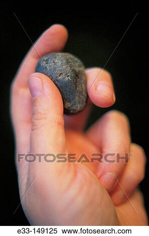 Stone in hand View Large Photo Image Stock Photography - Stone in hand. Fotosearch