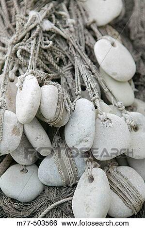 Stock Photograph - Stones in fishing net, historical type. Gotland. Sweden. Fotosearch