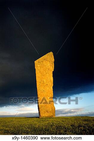 Stones of Stenness, Orkney, Scotland, UK Tallest of the prehistoric stone circle stones lit by setting sun against rain cloud View Large Photo Image Stock Image - Stones of Stenness, Orkney, Scotland, UK Tallest of the prehistoric stone circle stones lit by setting sun against rain cloud. Fotosearch