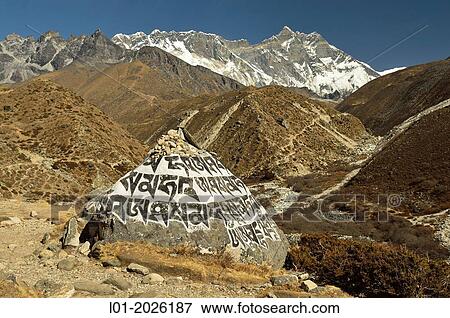 Stones with prayers. Lhotse mountain (8501 m) in the background. Sagarmatha National Park (Nepal). View Large Photo Image Stock Photo - Stones with prayers. Lhotse mountain (8501 m) in the background. Sagarmatha National Park (Nepal).. Fotosearch