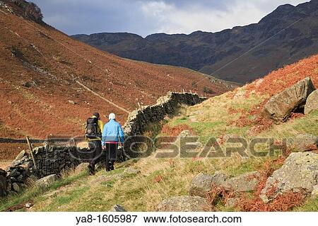 Stonethwaite Borrowdale Cumbria England UK Europe Two people walking on the Cumbria Way path through Langstrath Valley in the Lake District National Park MR 11/36, MR 11/39 View Large Photo Image Stock Photo - Stonethwaite Borrowdale Cumbria England UK Europe Two people walking on the Cumbria Way path through Langstrath Valley in the Lake District National Park MR 11/36, MR 11/39. Fotosearch
