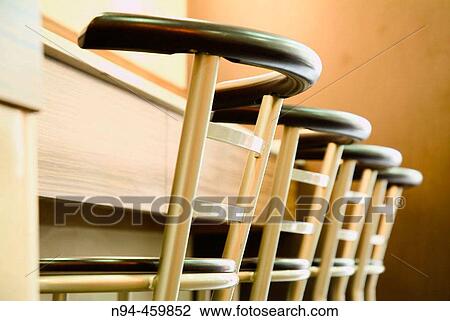 Stools lined up against the bar of a restaurant. View Large Photo Image Stock Image - Stools lined up against the bar of a restaurant.. Fotosearch