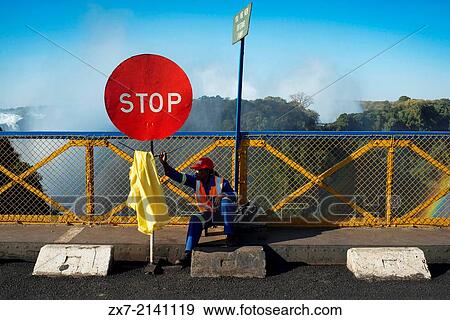 Stop sign at the Zambia and Zimbabwe border bridge. The Victoria Falls Bridge is 100 years old in 2005. View Large Photo Image Stock Photo - Stop sign at the Zambia and Zimbabwe border bridge. The Victoria Falls Bridge is 100 years old in 2005.. Fotosearch