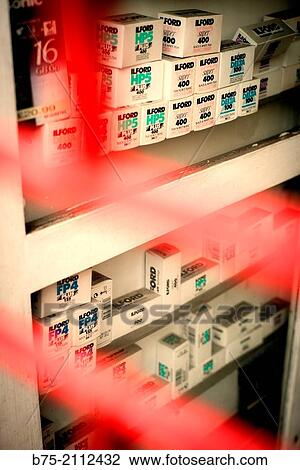 Stock Image - Store shelves of a closed photographic shop with film boxes brand Ilford, FP4, HP5, Super 400 and Delta 100, in Withechapel, East London, England, UK, Europe.. Fotosearch