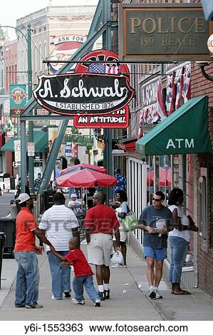 Stock Image - Store signs and afternoon visitors on Beale Street Memphis USA. Fotosearch