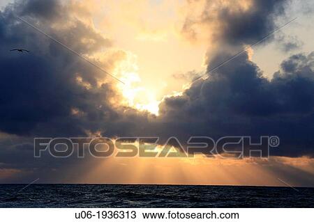 Storm clouds and sun bursts over a rough sea in the Caribbean View Large Photo Image Stock Image - Storm clouds and sun bursts over a rough sea in the Caribbean. Fotosearch