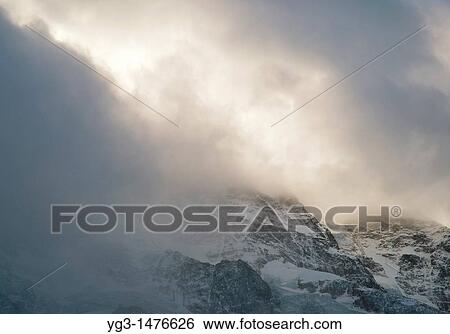 stormclouds forming over mountain in swiss alps View Large Photo Image Stock Photograph - stormclouds forming over mountain in swiss alps. Fotosearch