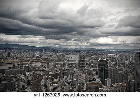 Stormy clouds over the city of Osaka, Japan. Bridges are crossing river yodo. View Large Photo Image Stock Photography - Stormy clouds over the city of Osaka, Japan. Bridges are crossing river yodo.. Fotosearch