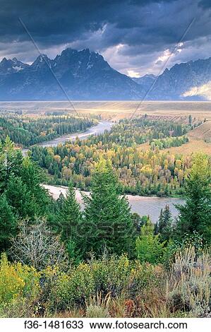 Stormy sunrise over the Grand Tetons from the Snake River Overlook, Grand Teton National Park, WYOMING View Large Photo Image Stock Image - Stormy sunrise over the Grand Tetons from the Snake River Overlook, Grand Teton National Park, WYOMING. Fotosearch