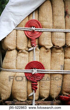 Straw bags tied with strings View Large Photo Image Stock Image - Straw bags tied with strings. Fotosearch