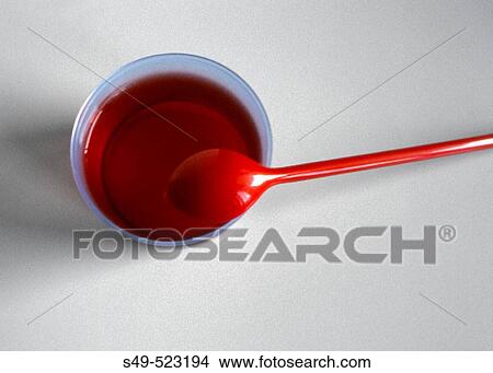 Picture - Strawberry jelly and red plastic spoon. Fotosearch