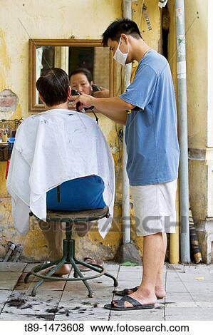 Street barber cuts a man hair in old hanoi. View Large Photo Image Stock Photo - Street barber cuts a man hair in old hanoi.. Fotosearch