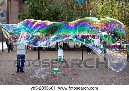 Stock Image - Street Entertainment Outside Tate Modern, London, England.. Fotosearch