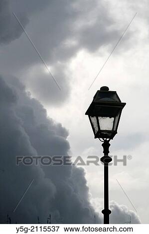 street lamp against dark clouds in rome italy View Large Photo Image Stock Photo - street lamp against dark clouds in rome italy. Fotosearch