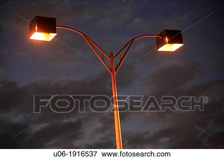 Street lights lit at night on a street in Florida USA View Large Photo Image Stock Photo - Street lights lit at night on a street in Florida USA. Fotosearch