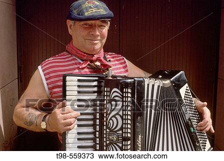 Stock Image - street musician playing an accordian, Glasgow, Scotland. UK.. Fotosearch