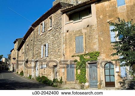 Stock Image - Street of Gordes village, labeled The Most Beautiful Villages of France, Vaucluse department, Provence-Alpes-Cote d'Azur region. France.. Fotosearch