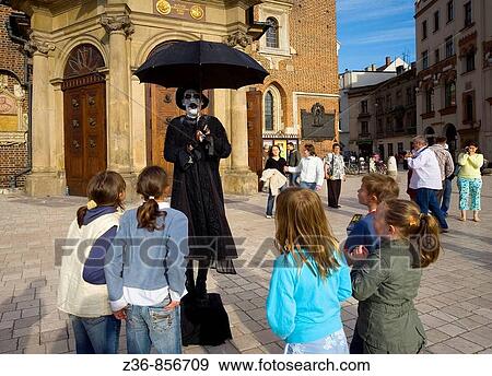 Street performer at Main Market Square, Krakow, Poland View Large Photo Image Stock Photo - Street performer at Main Market Square, Krakow, Poland. Fotosearch