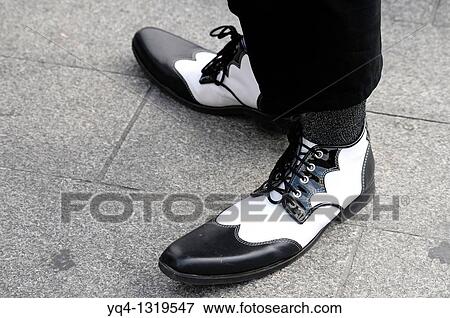Street performers, Clowns Without Borders in the Puerta del Sol de Madrid. Details of clown shoes. View Large Photo Image Stock Photo - Street performers, Clowns Without Borders in the Puerta del Sol de Madrid. Details of clown shoes.. Fotosearch