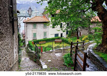 Stock Photography - street scene in Corenno Plinio, Lake Como in the background, commune Dervio, Lombardy, Italy. Fotosearch