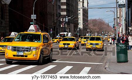 Stock Image - Street scene with cabs going downtown on Fifth Avenue in Manhattan, New York, NY, USA.. Fotosearch
