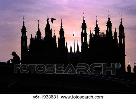 Stock Image - Street vendor on Westminster Bridge with the Houses of Parliament in the background caught in the rather disturbed light of a Winter dusk in London, England.. Fotosearch