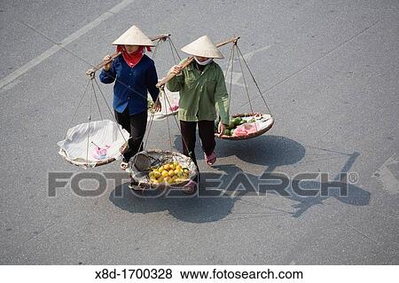 Street vendors with baskets crossing the street, Old Quarter, Hanoi, Vietnam View Large Photo Image Stock Photo - Street vendors with baskets crossing the street, Old Quarter, Hanoi, Vietnam. Fotosearch