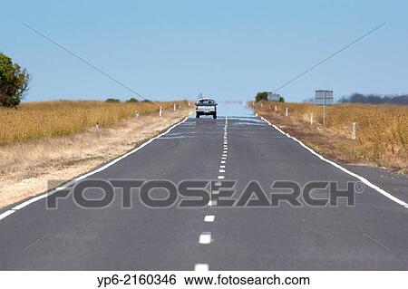 Stock Photograph - street with mirage in the heat, South Australia, Australia.. Fotosearch
