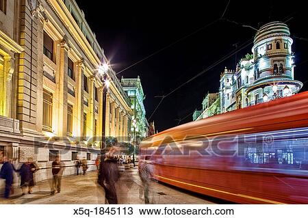 Stock Image - Streetcar at night on Constitution Avenue, Seville, Spain. Fotosearch