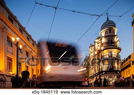 Streetcar at night on Constitution Avenue, Seville, Spain View Large Photo Image Stock Photo - Streetcar at night on Constitution Avenue, Seville, Spain. Fotosearch