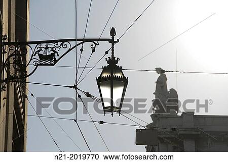 Streetlamp. In the background, the top of the Arco do Triunfo. Baixa, Lisbon, Portugal. View Large Photo Image Stock Image - Streetlamp. In the background, the top of the Arco do Triunfo. Baixa, Lisbon, Portugal.. Fotosearch