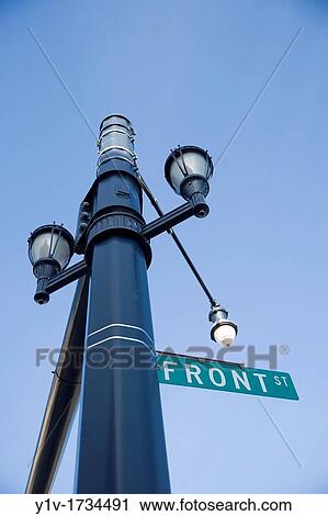 Streetlamps and a? Front Street? sign on a lamppost View Large Photo Image Stock Image - Streetlamps and a? Front Street? sign on a lamppost. Fotosearch