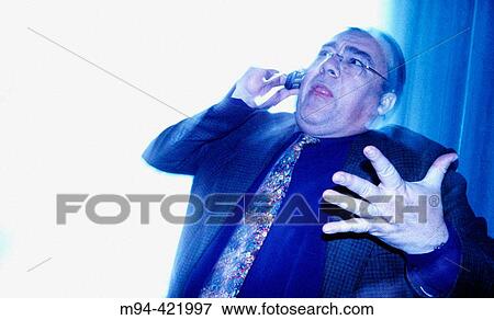 Stock Photo - Stressed businessman talking on the phone.. Fotosearch