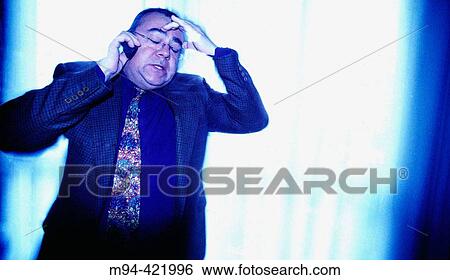 Stock Photograph - Stressed businessman talking on the phone.. Fotosearch
