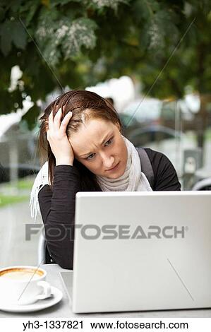 Stressed young woman with a laptop outdoor View Large Photo Image Stock Image - Stressed young woman with a laptop outdoor. Fotosearch