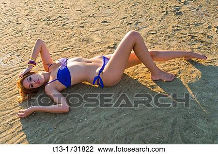 Stretching on a beach young woman View Large Photo Image Stock Image - Stretching on a beach young woman. Fotosearch